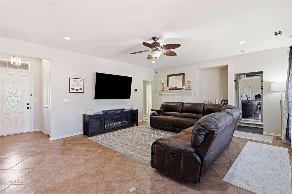 5642 County Road 597, Farmersville, TX 75442 Living room has tile floors for easy clean up and plenty of room for oversized couch.