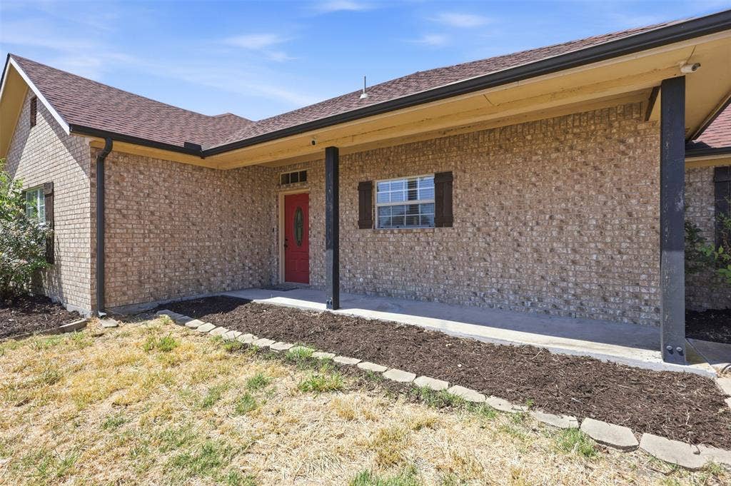 5642 County Road 597, Farmersville, TX 75442 Large covered front porch and defined flower beds welcome you home!