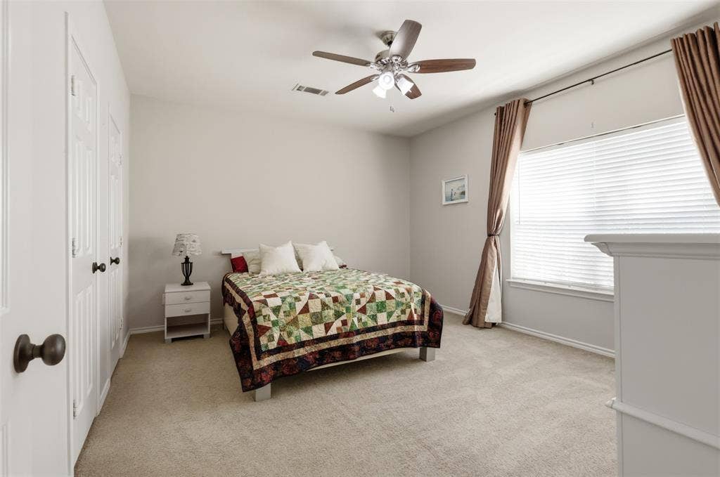 5642 County Road 597, Farmersville, TX 75442 Secondary bedroom with large window and ceiling fan.