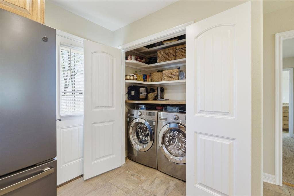 213 Freeman Street, Lindale, TX 75771 Built-in laundry appliances with wood-finish shelving, paneled doors, and tiled flooring