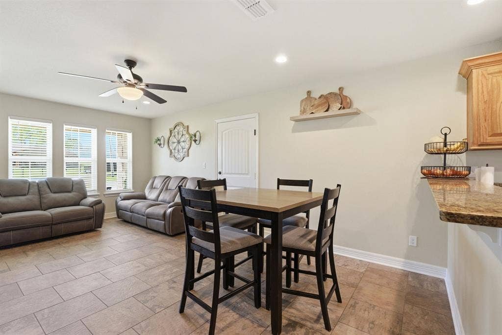 213 Freeman Street, Lindale, TX 75771 Open-concept living space with tile flooring, a ceiling fan, and recessed lighting