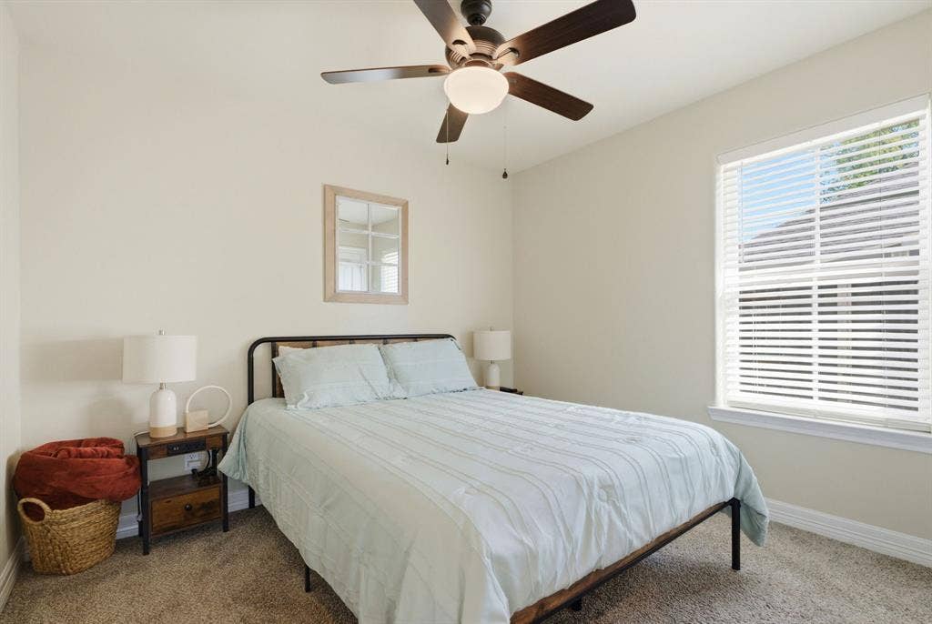 213 Freeman Street, Lindale, TX 75771 Recessed window with horizontal blinds, ceiling fan with integrated lighting, and carpeted flooring