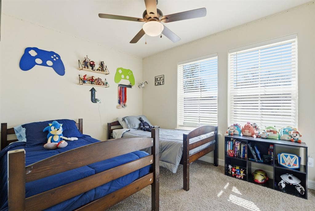 213 Freeman Street, Lindale, TX 75771 Recessed lighting, ceiling fan, two windows with blinds, and carpeted flooring