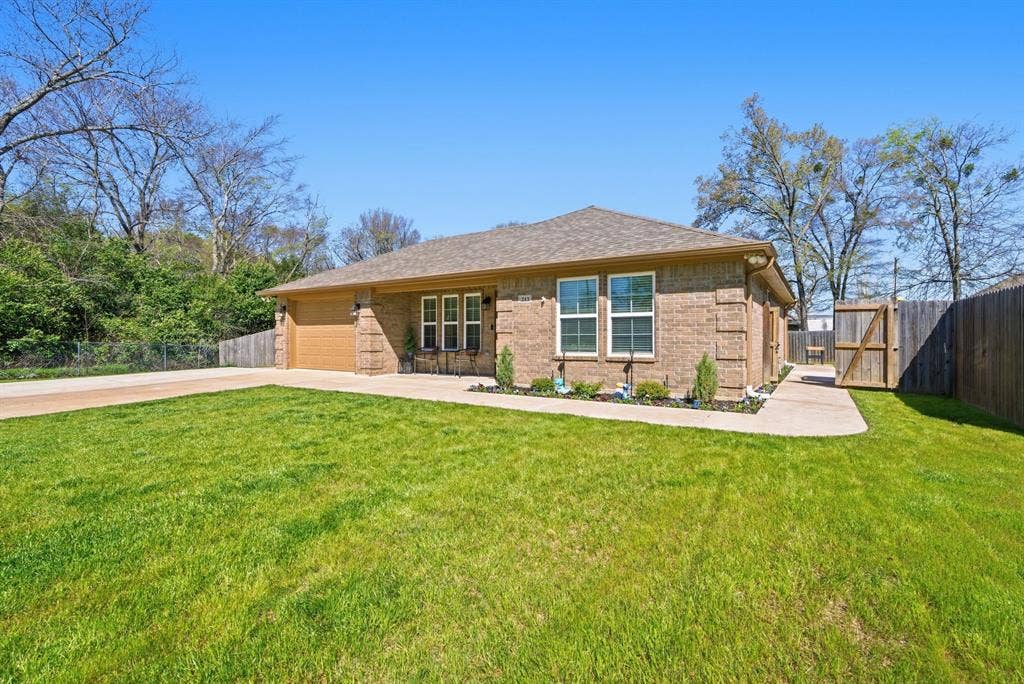 213 Freeman Street, Lindale, TX 75771 Brick exterior with a gabled roof and attached garage