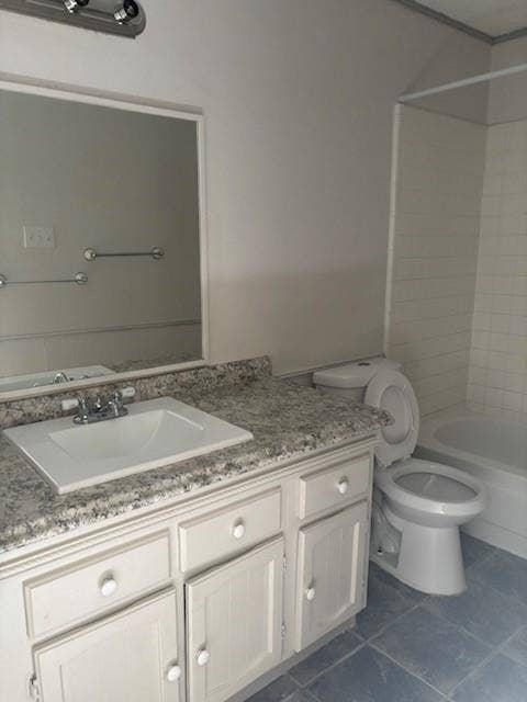 2805 Woodmont Trail, Fort Worth, TX 76133 Vanity with an integrated sink, speckled countertop, and white cabinetry