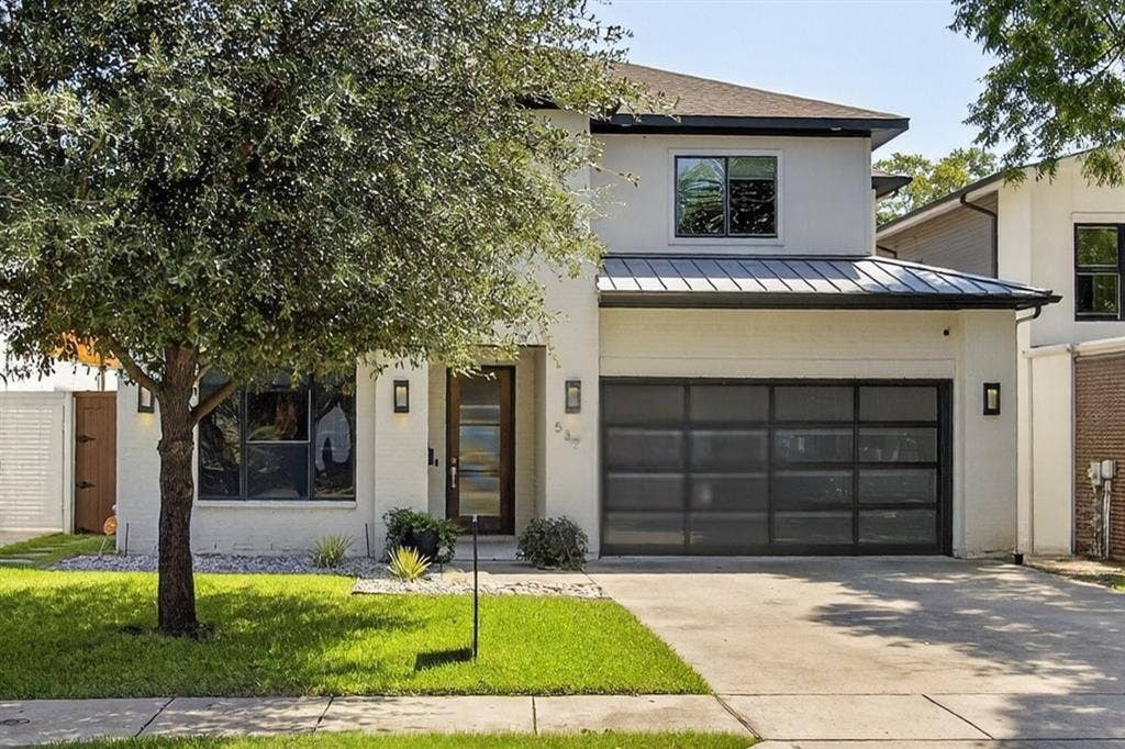 5328 Manett Street, Dallas, TX 75206 Contemporary exterior with a modern garage door, sleek exterior lighting fixtures, a prominent metal roof accent, and a well-maintained lawn
