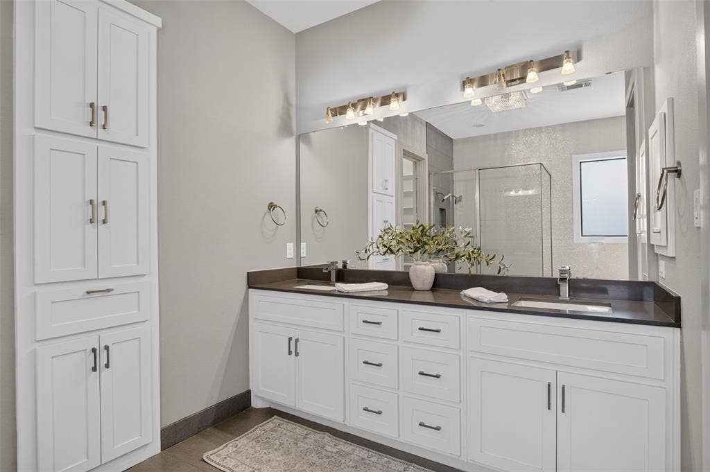 5328 Manett Street, Dallas, TX 75206 Dual vanity with dark countertops and undermount sinks