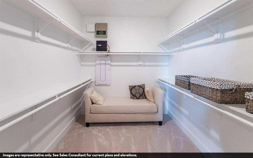 810 Metcalf Drive, Princeton, TX 75071 Carpeted flooring with extensive built-in shelving, and multiple hanging rods
