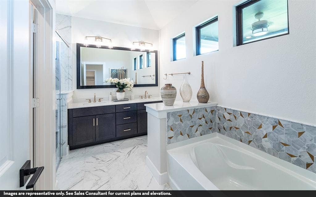 810 Metcalf Drive, Princeton, TX 75071 Dual vanity with dark wood-finish cabinetry, white countertops, and a large framed mirror