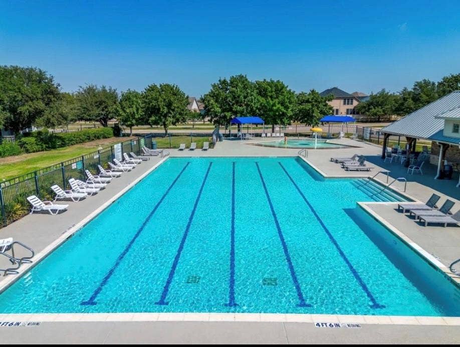 6241 Adonia Drive, Fort Worth, TX 76131 Expansive swimming pool with integrated lane lines and a dedicated shallow-entry area