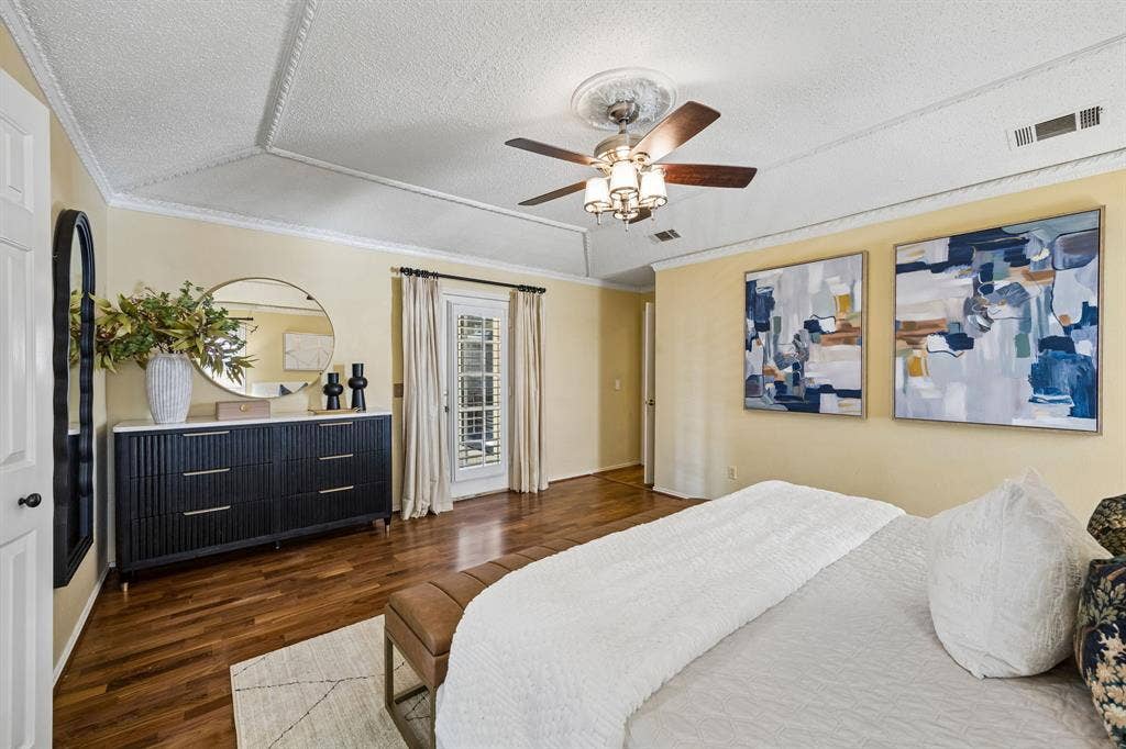 The primary bedroom has plenty of room for large pieces of furniture or a sitting area. There is also a door to the back patio.