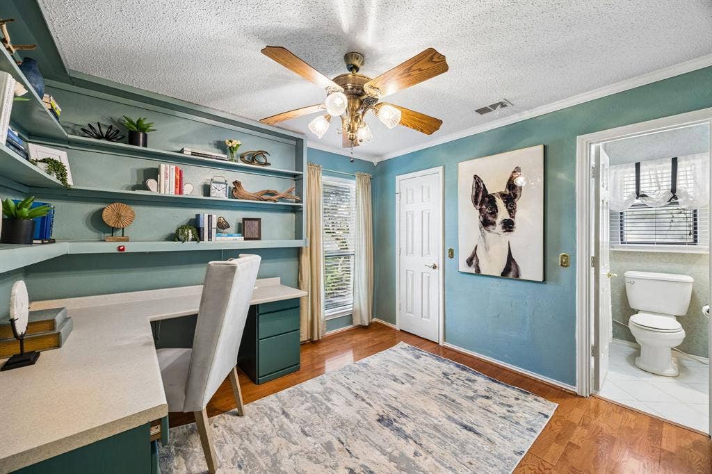 The secondary bedroom is perfect for a home office with built-in shelves.