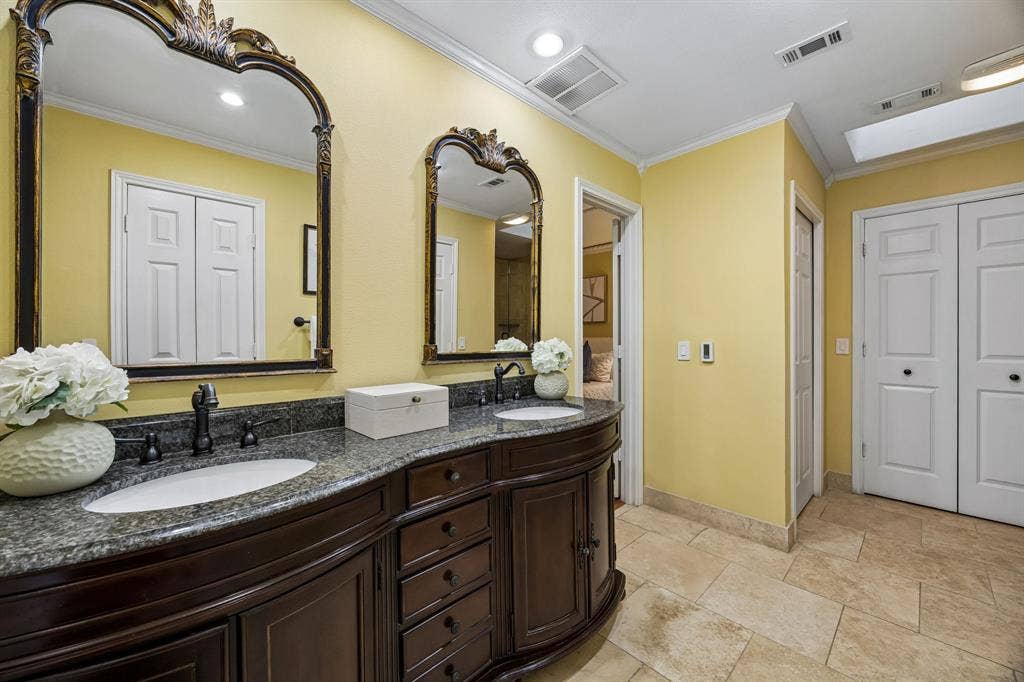 The primary bathroom features a double vanity with storage and the real bonus is the heated floors!