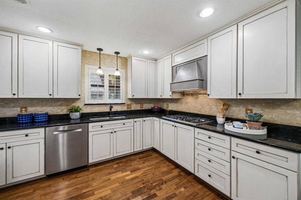 The kitchen offers custom cabinets, several with roll-out drawers and specialty storage.