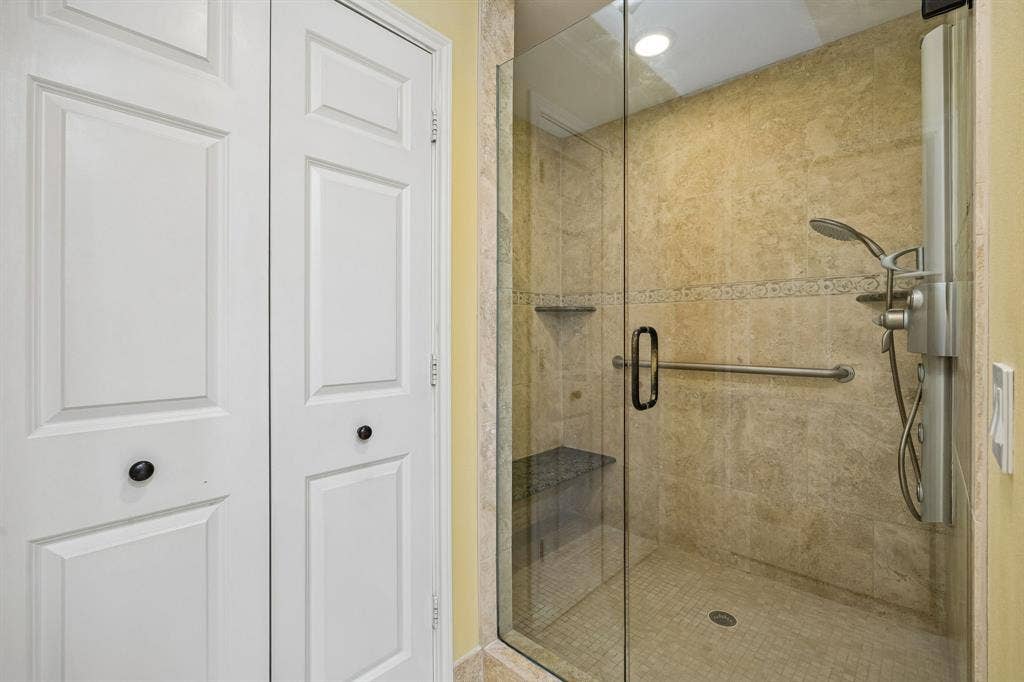 The primary bath features an updated, large walk0in shower a linen closet and separate water closet with a pocket door.
