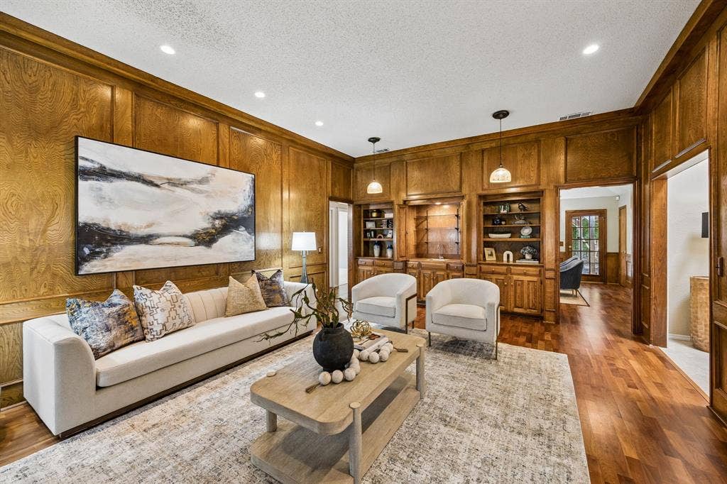 The living room features a wet bar and storage shelves.