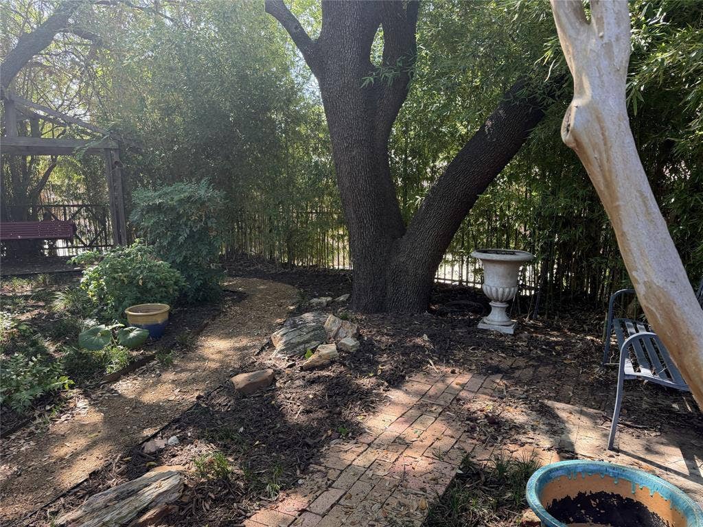 The backyard features mature trees and several garden spots to saunter through and take in the season colors.