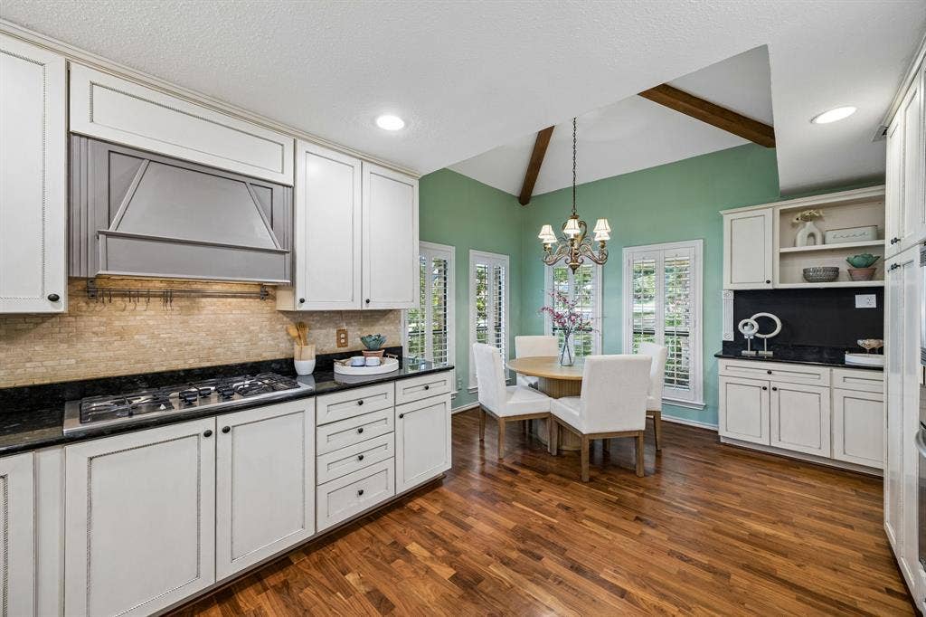 The kitchen has a gas cooktop and separate wall oven and microwave.