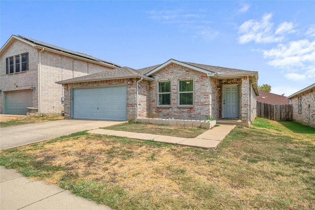 8421 Cotton Valley Lane, Arlington, TX 76002 Brick exterior facade with a light-colored entry door, an attached garage, and a concrete driveway