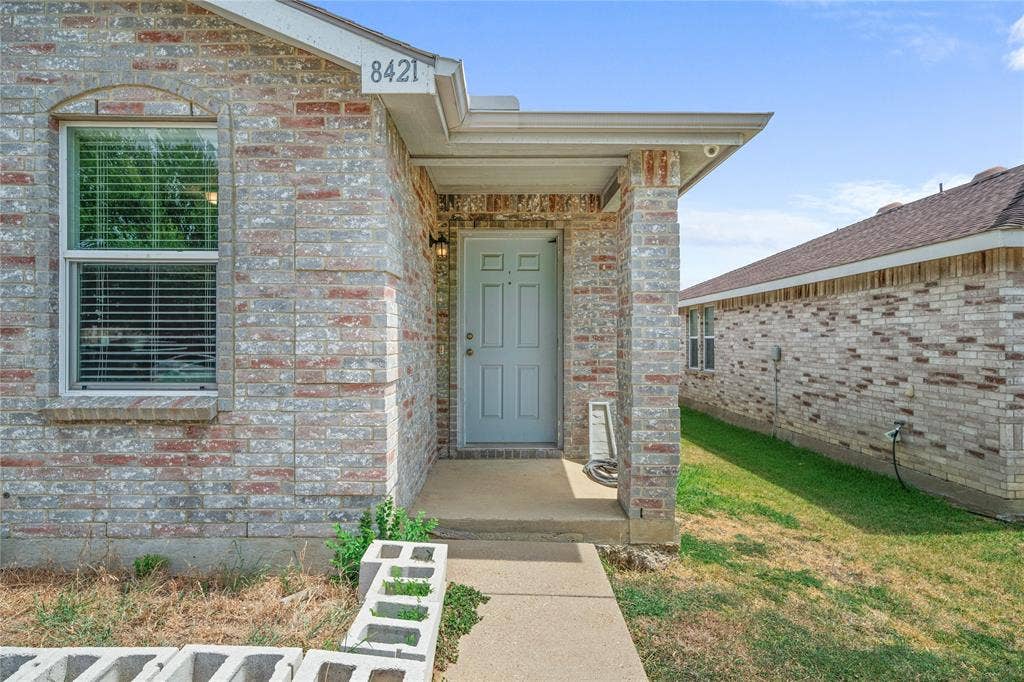 8421 Cotton Valley Lane, Arlington, TX 76002 Brick exterior with covered entry and concrete walkway