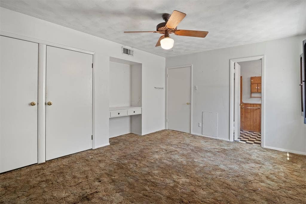 Built-in desk area, dual closets, and ceiling fan with integrated lighting