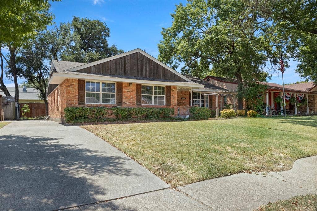 Brick exterior with a gabled roofline and board and batten siding