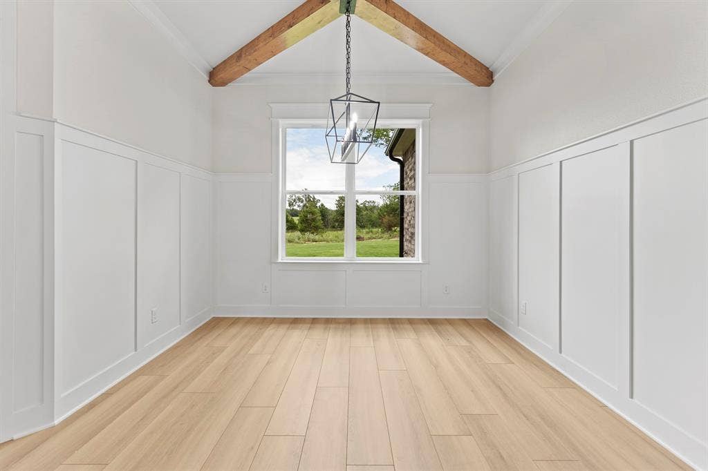 13914 Cedar Hill Lane, Tyler, TX 75704 Vaulted ceiling with exposed wood beams, wood-finish flooring, paneled wainscoting, and a geometric pendant light fixture