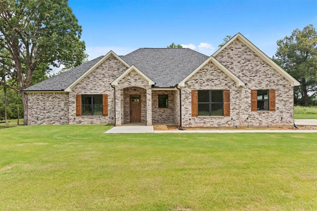 13914 Cedar Hill Lane, Tyler, TX 75704 Brick exterior with gabled roof lines, dark-framed windows, and wood-finish shutters