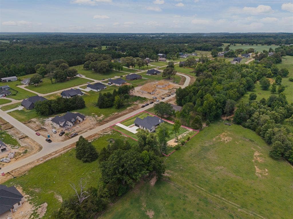 13914 Cedar Hill Lane, Tyler, TX 75704 Aerial perspective showcasing residential development with paved streets, surrounded by expansive green spaces and mature trees
