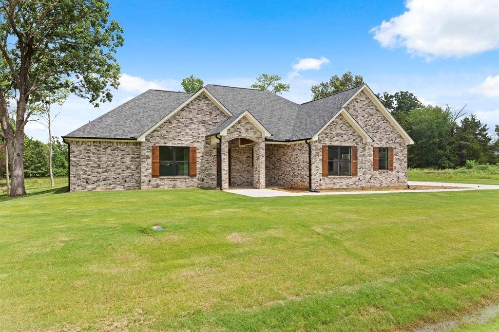 13914 Cedar Hill Lane, Tyler, TX 75704 Brick exterior with a dark-pitched roof, gabled accents, and contrasting wood-finish shutters