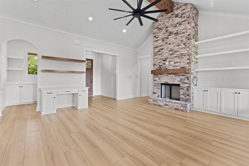 13914 Cedar Hill Lane, Tyler, TX 75704 Vaulted ceiling with exposed wood beam, wood-finish flooring, floor-to-ceiling brick fireplace with wood mantel, built-in shelving, and recessed lighting