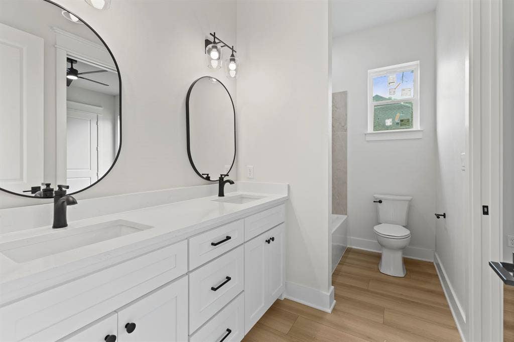 13914 Cedar Hill Lane, Tyler, TX 75704 Dual vanity with white cabinetry, matte black hardware, and integrated sinks