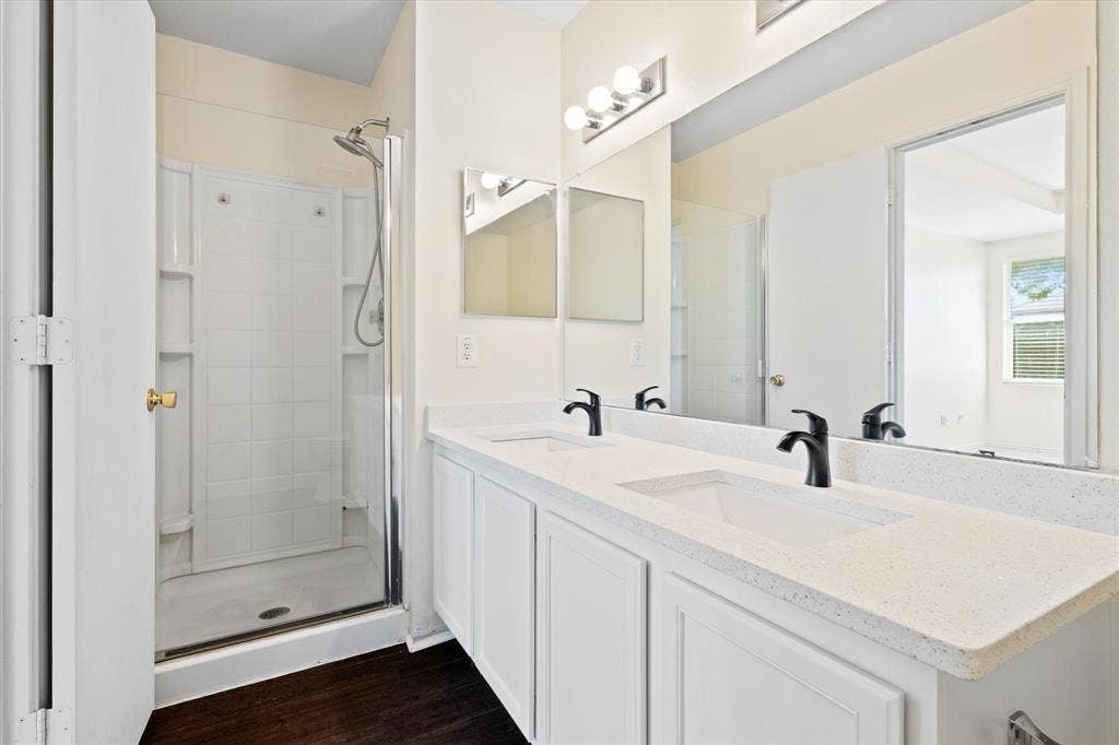 12856 Gillon Drive, Frisco, TX 75035 Full bath featuring double vanity, wood finished floors, and a shower