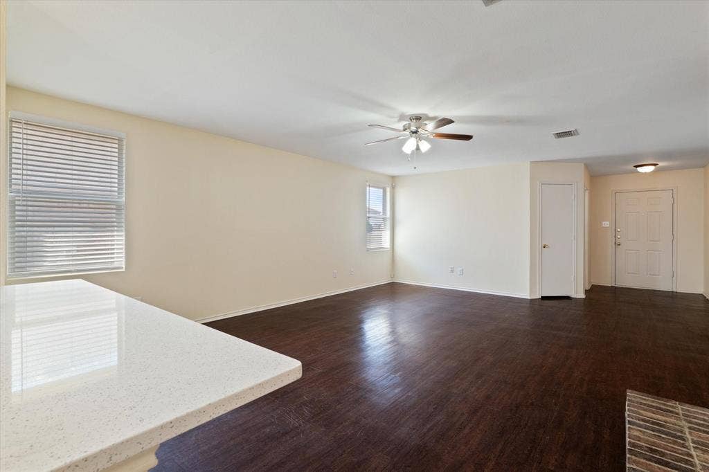 12856 Gillon Drive, Frisco, TX 75035 Unfurnished living room with ceiling fan and dark wood-style flooring