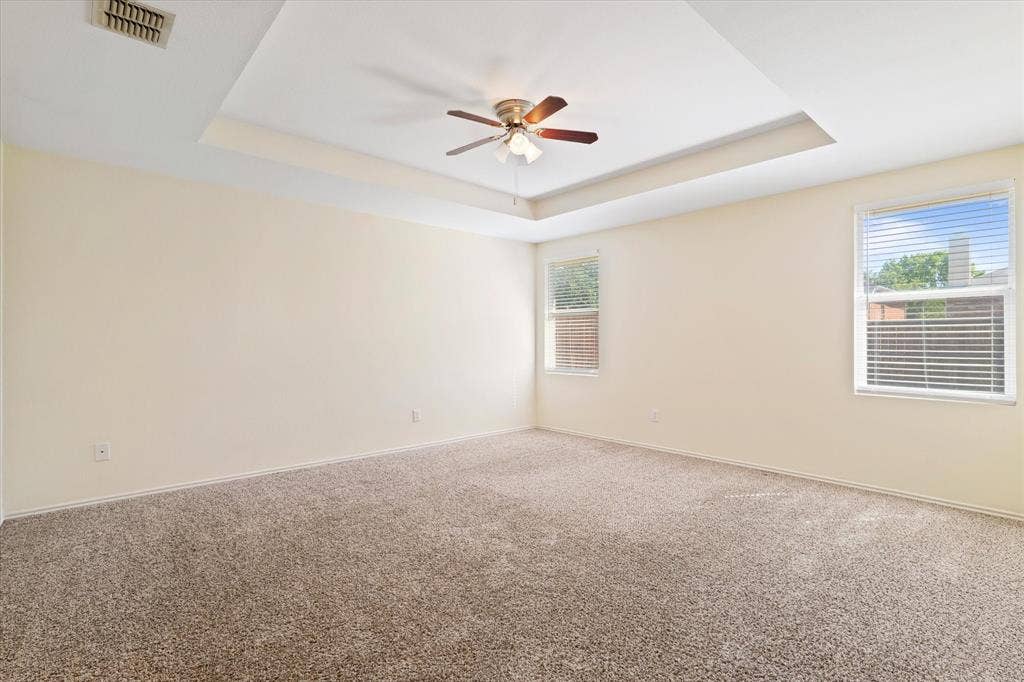 12856 Gillon Drive, Frisco, TX 75035 Unfurnished room with a tray ceiling, a ceiling fan, and carpet