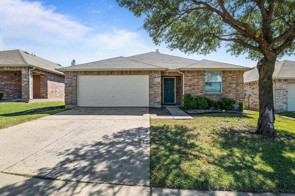 12856 Gillon Drive, Frisco, TX 75035 Ranch-style home with driveway, a garage, roof with shingles, a front yard, and brick siding
