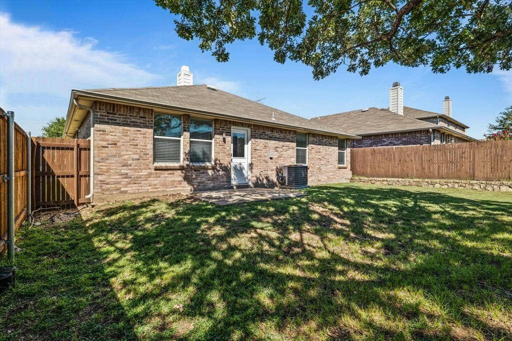 12856 Gillon Drive, Frisco, TX 75035 Rear view of property with brick siding, a fenced backyard, a chimney, and roof with shingles