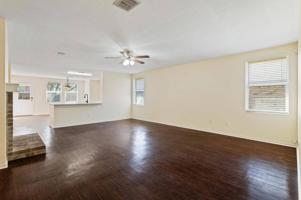 12856 Gillon Drive, Frisco, TX 75035 Unfurnished living room featuring ceiling fan and dark wood-style flooring