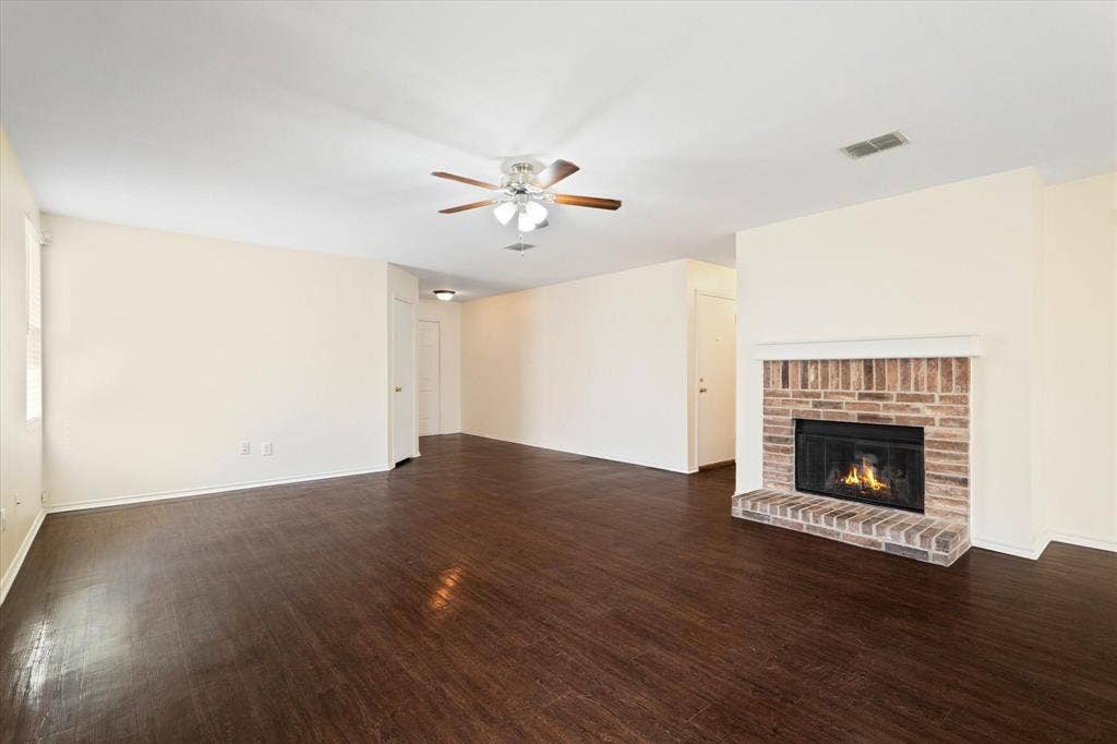 12856 Gillon Drive, Frisco, TX 75035 Unfurnished living room with a ceiling fan, wood finished floors, and a fireplace