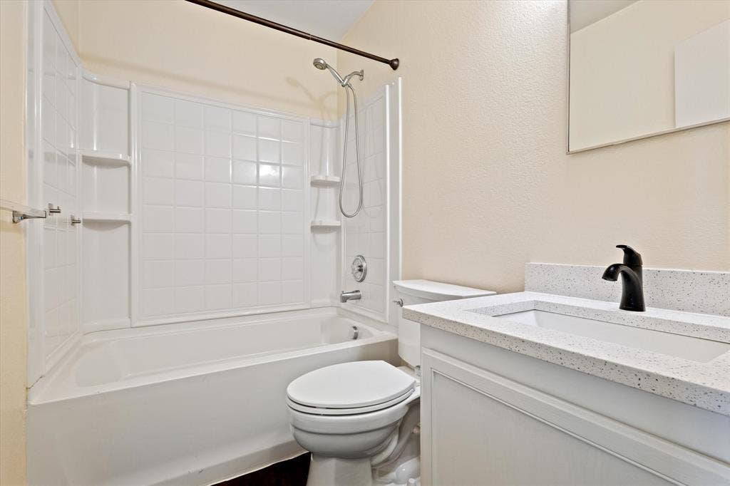 12856 Gillon Drive, Frisco, TX 75035 Bathroom featuring vanity and shower combination