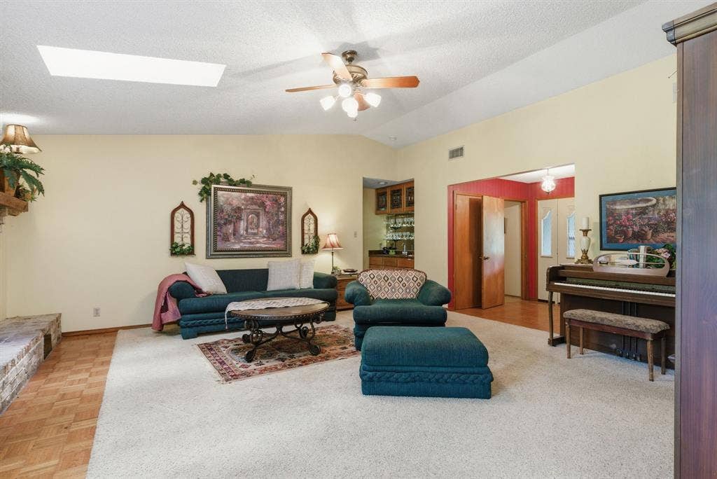 6146 County Road 334, Tyler, TX 75708 Vaulted ceiling with skylight and ceiling fan, built-in wet bar, and parquet wood flooring