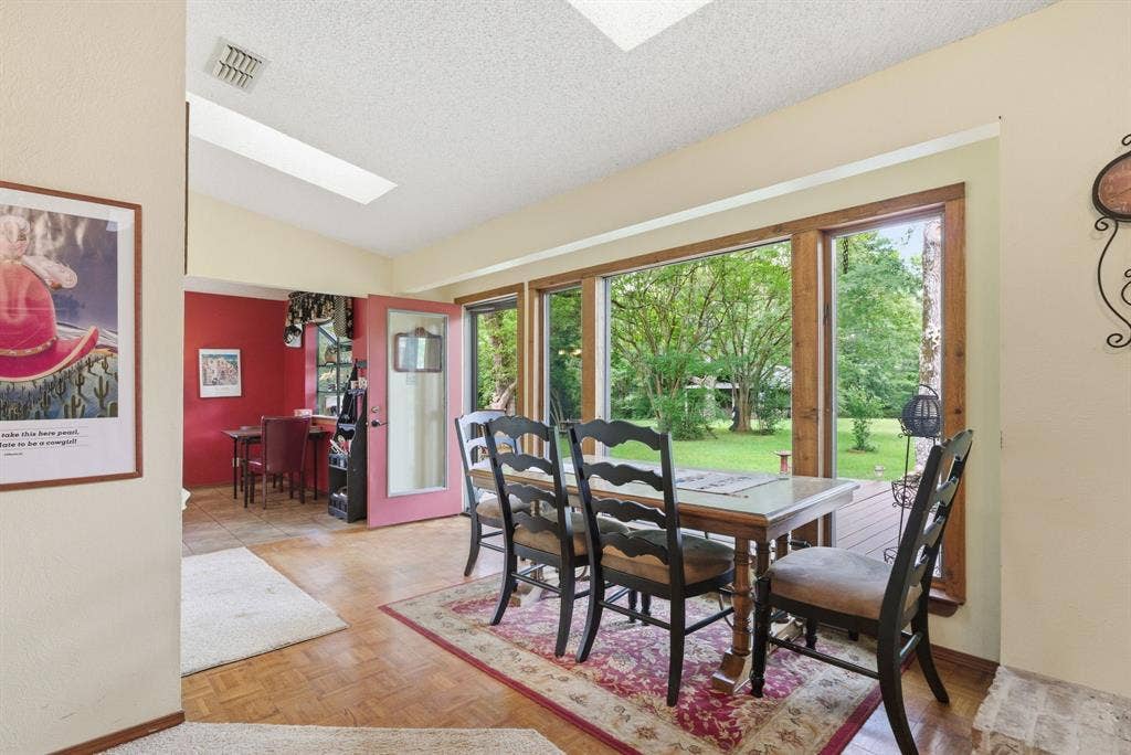 6146 County Road 334, Tyler, TX 75708 Parquet wood flooring, a skylight, and expansive windows with wood trim