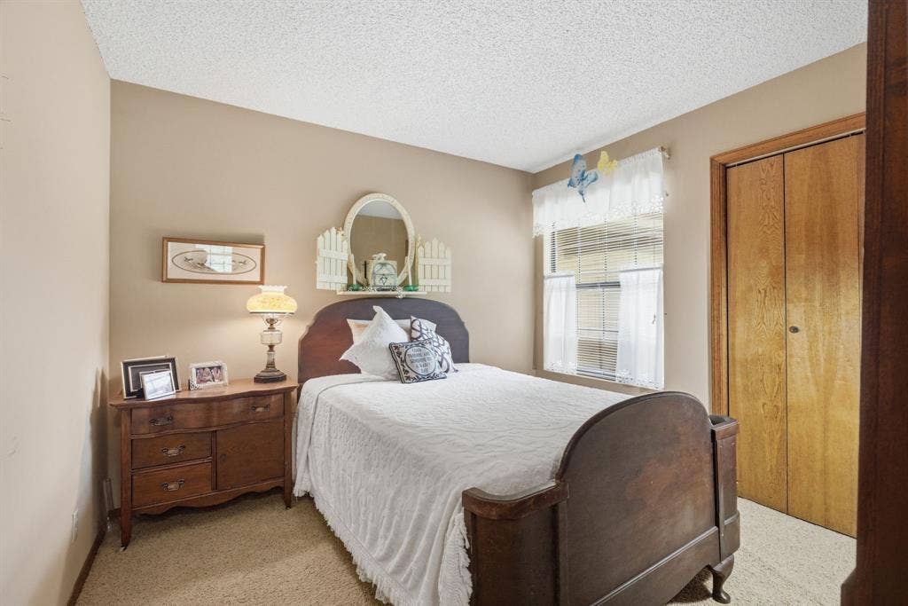 6146 County Road 334, Tyler, TX 75708 Wall-to-wall carpeting, neutral wall color, window with blinds, and bi-fold closet doors