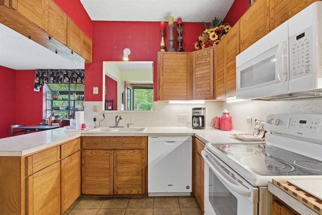 6146 County Road 334, Tyler, TX 75708 Wood-finish cabinetry paired with white countertops and white appliances