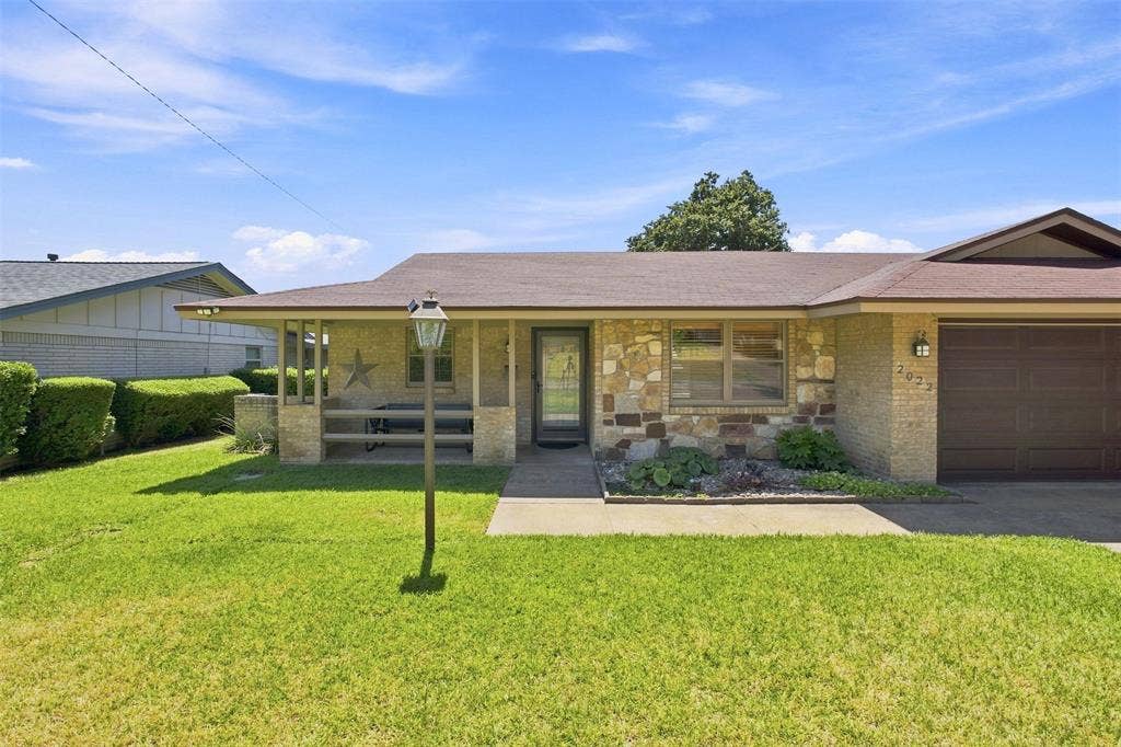 2022 Normandy Drive, Irving, TX 75060 Stone and brick veneer exterior with an attached garage