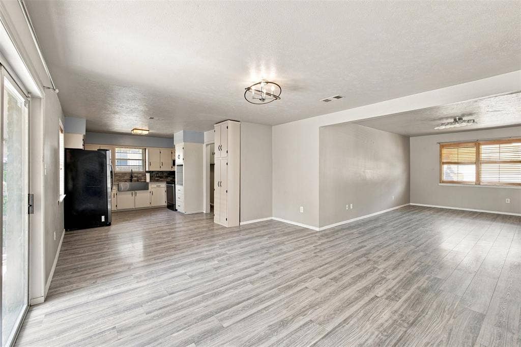 2022 Normandy Drive, Irving, TX 75060 Expansive living area with wood-finish flooring, recessed lighting, and a modern ceiling fixture