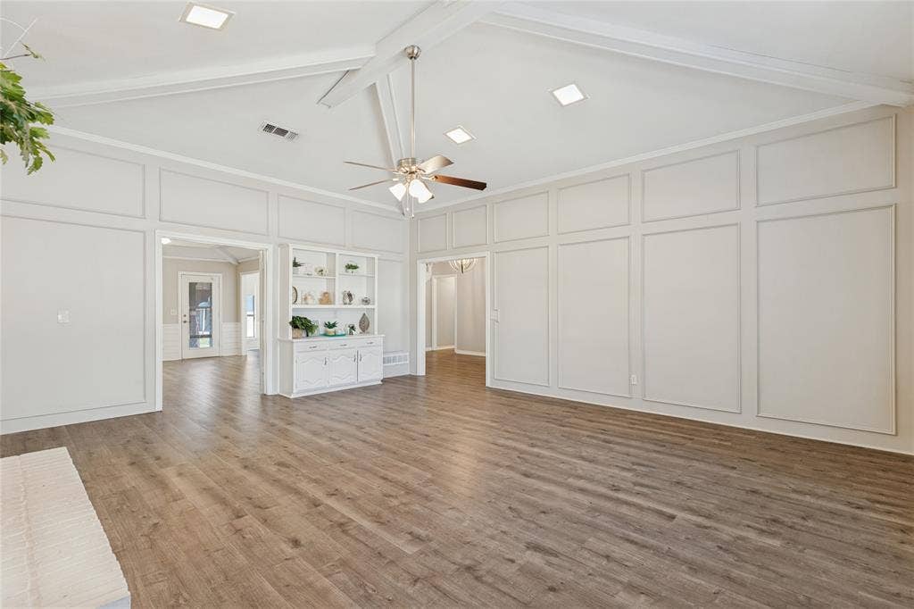 5013 Country Place Drive, Plano, TX 75023 Vaulted ceiling with exposed beams, wood-finish flooring, recessed lighting, ceiling fan, and built-in cabinetry with open shelving, just an amazing room!