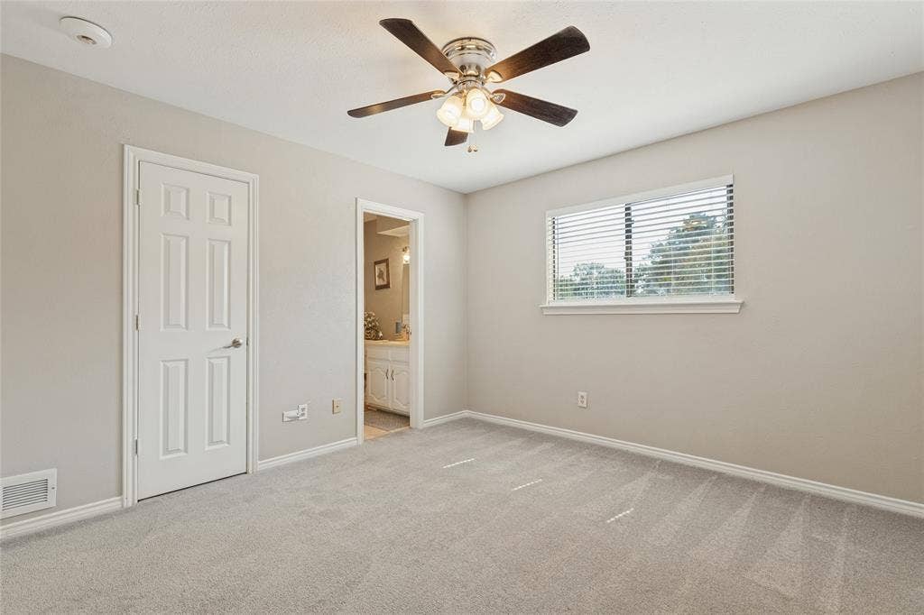 5013 Country Place Drive, Plano, TX 75023 Upstairs second primary bedroom, with ensuite bath, ceiling fan with light fixture, carpeted flooring
