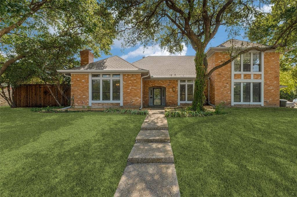 5013 Country Place Drive, Plano, TX 75023 Brick exterior with white trim, multiple large windows, and a prominent front entry.