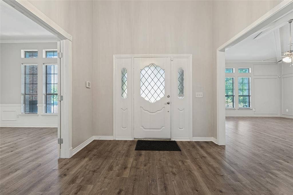 5013 Country Place Drive, Plano, TX 75023 Entryway featuring wood-finish flooring, a white front door with leaded glass inserts, and high ceilings